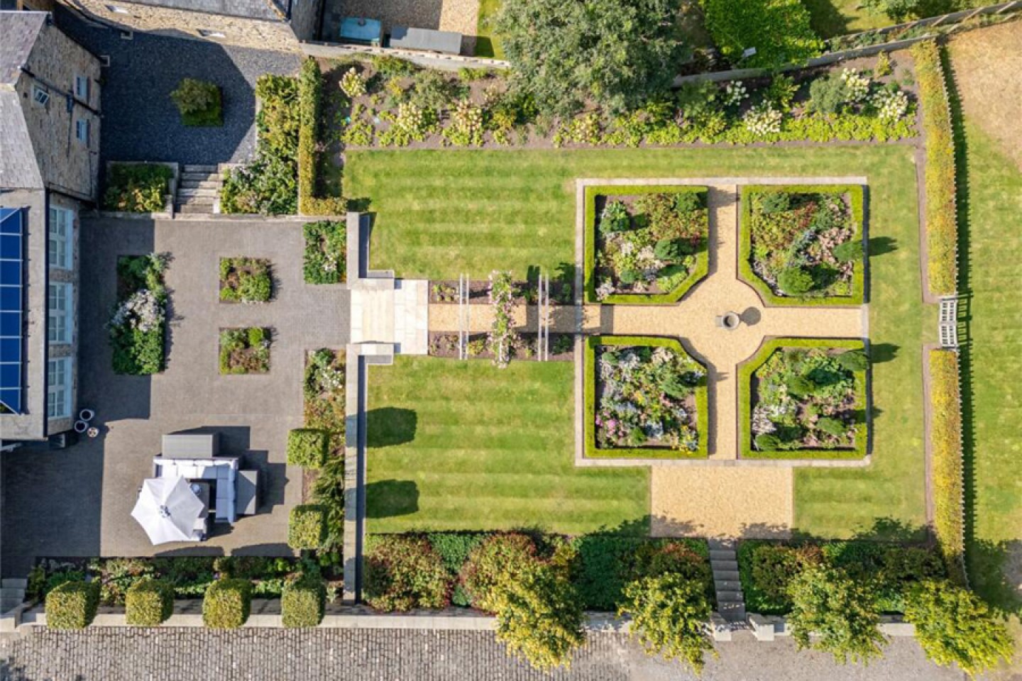 Ariel view of a patio terrace with seating and landscaped garden 